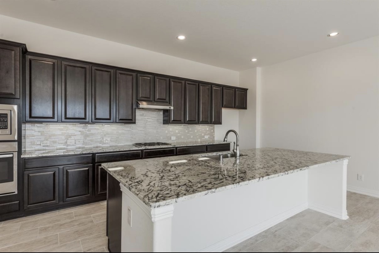 3223 Harmony Creek Lane Spring, TX 77386 - Photo 8 of 34 a kitchen with stainless steel appliances granite countertop a sink counter space cabinets and stainless steel appliances