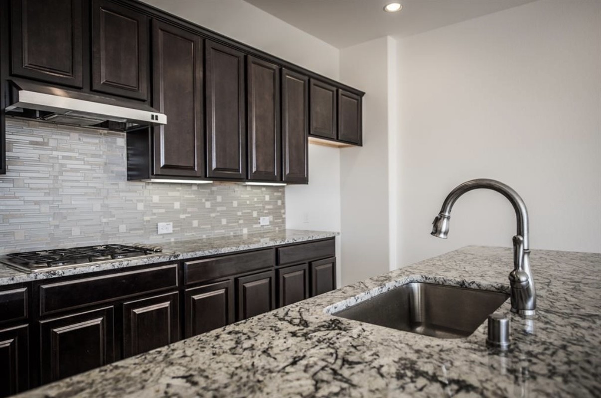 3223 Harmony Creek Lane Spring, TX 77386 - Photo 10 of 34 a kitchen with a stove and a sink