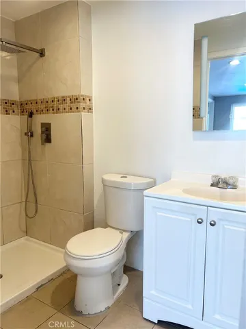 a bathroom with a toilet a sink and shower