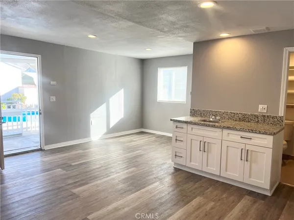 a view of a kitchen with a sink and a stove top oven