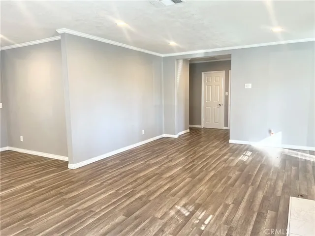 a view of a room with wooden floor and bathroom