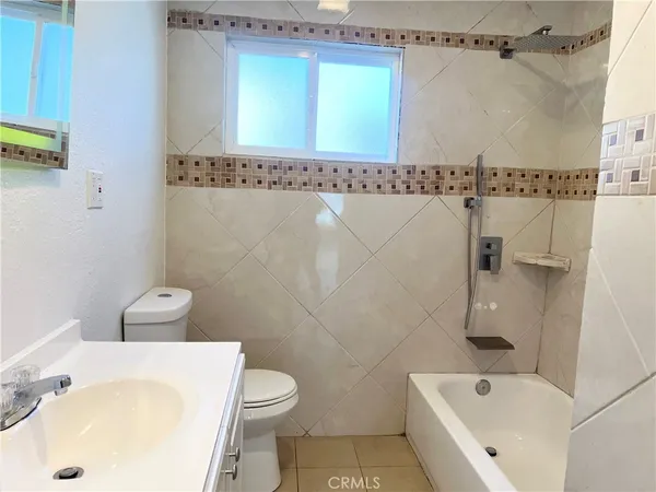 a bathroom with a sink a mirror and a toilet