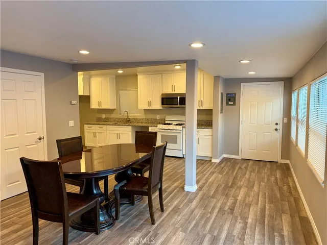 a view of a dining room with furniture window and wooden floor