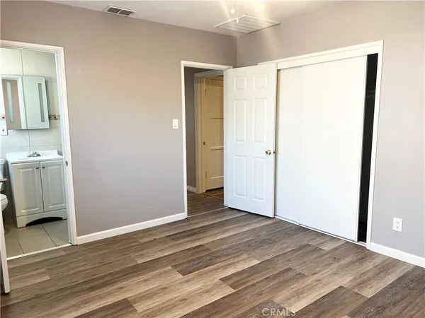 a view of a room with wooden floor and a bathroom sink