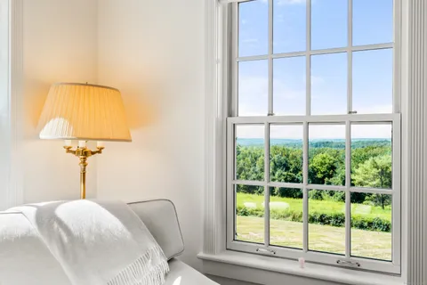 a view of hallway with cabinets and chandelier