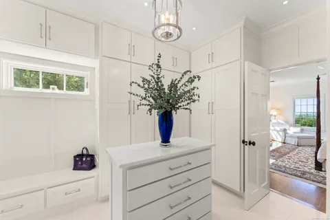 a spacious bathroom with a double vanity sink a mirror and a bathtub