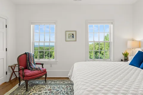 a view of a patio with table and chairs and wooden floor