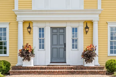 a view of a house with a potted plant and a window