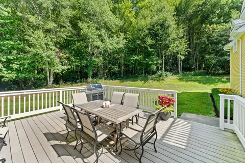 a view of a bench in the garden near a lake