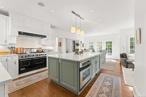 a kitchen with stainless steel appliances granite countertop a stove and a sink