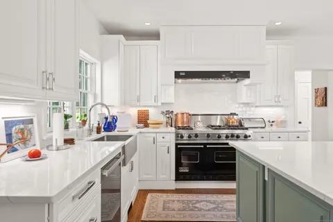 a kitchen with a sink stove and cabinets