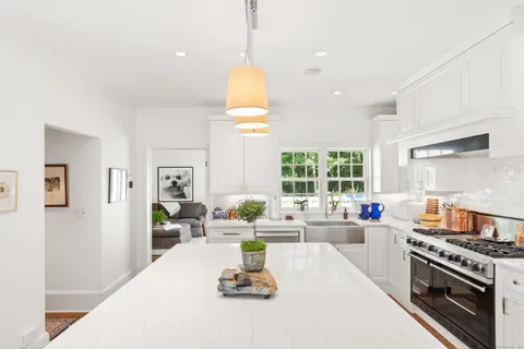 a kitchen with a large window cabinets and appliances