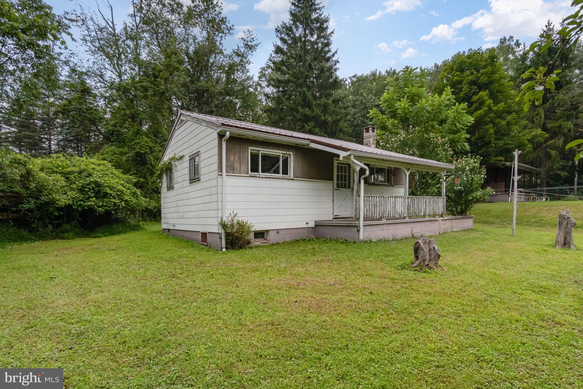 199 State Road Barnesville, PA 18214 - Photo 30 of 56 a backyard of a house with potted plants and large tree
