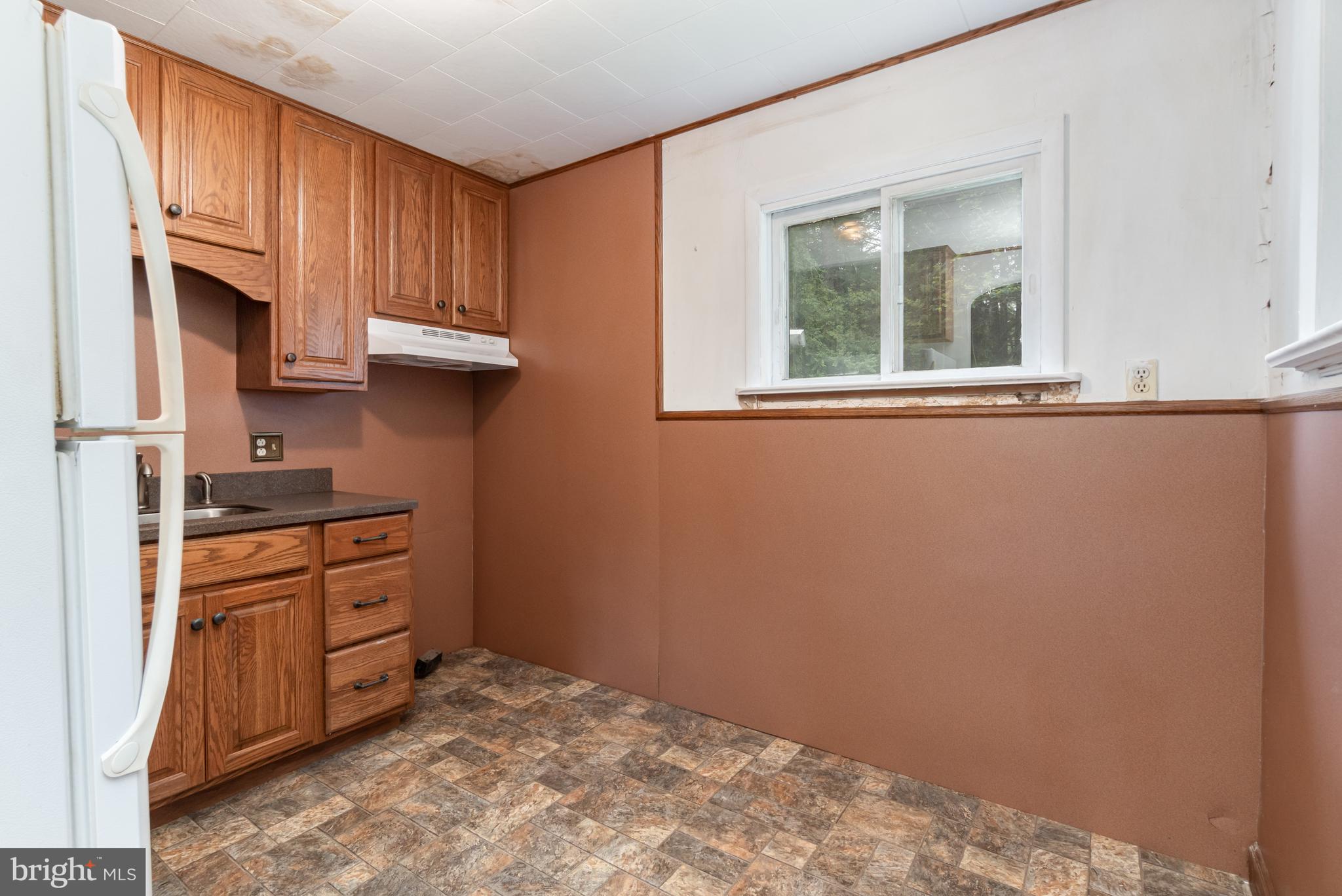 199 State Road Barnesville, PA 18214 - Photo 32 of 56 a kitchen with granite countertop a sink cabinets stainless steel appliances and a window