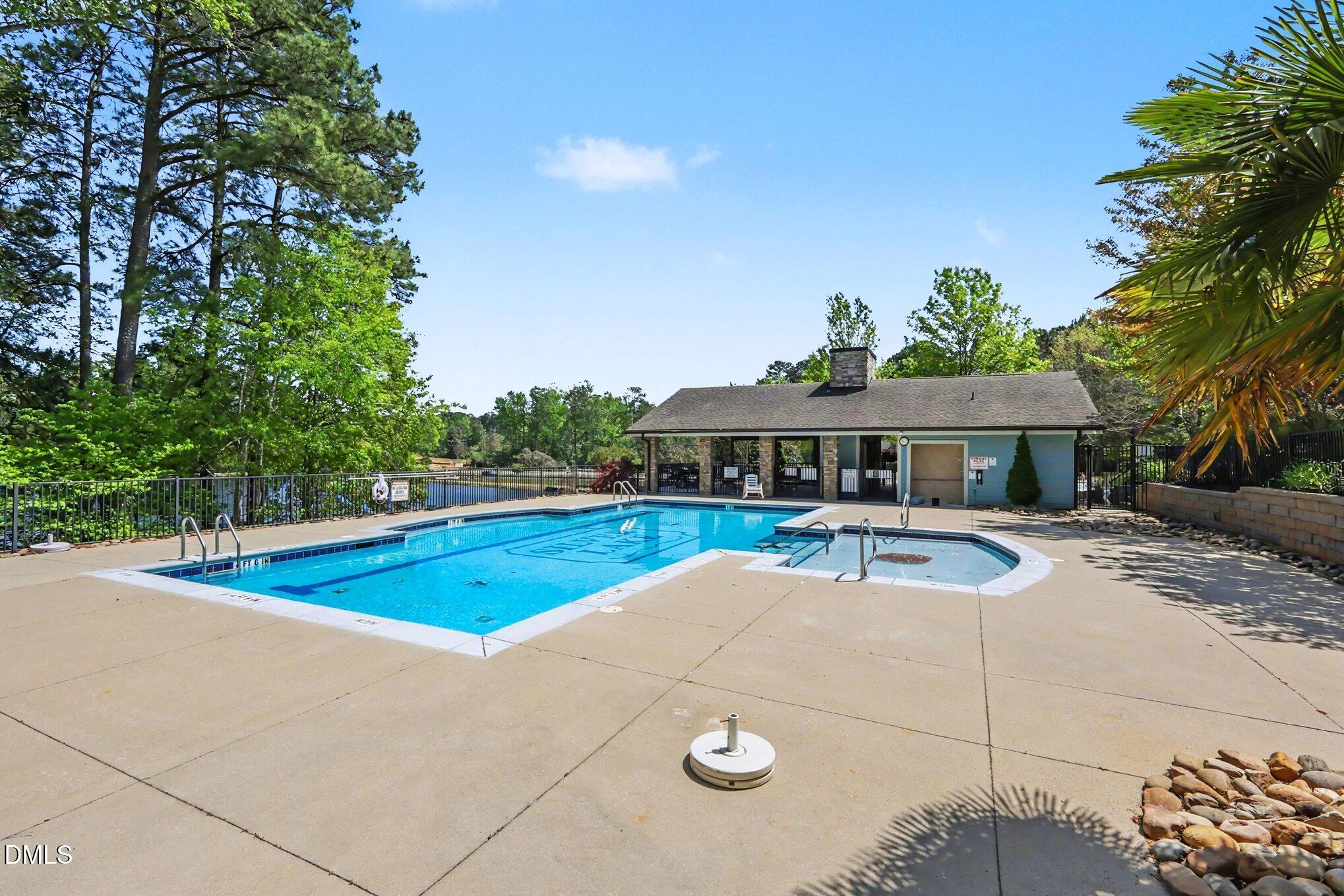 2409 Memory Ridge Drive Raleigh, NC 27606 - Photo 29 of 36 a view of pool with lawn chairs under an umbrella