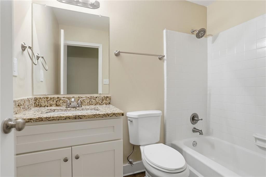 4505 Wonder Valley Trail Decatur, GA 30034 - Photo 23 of 34 a bathroom with a granite countertop toilet sink and mirror