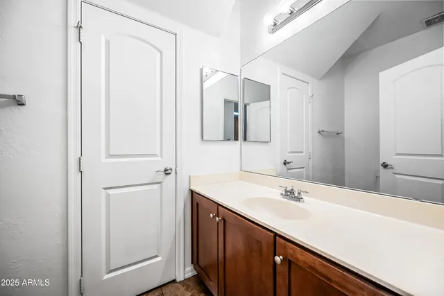 a bathroom with a sink and mirror