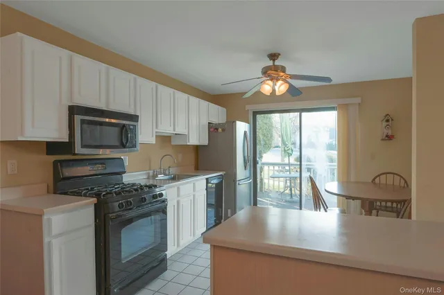 a kitchen with kitchen island granite countertop a stove and a sink