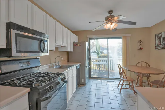 a kitchen with a stove a sink and a microwave