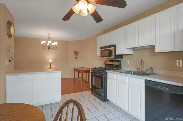 a kitchen with a sink stainless steel appliances and cabinets