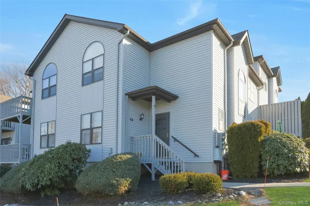 a view of a house with a yard and plants