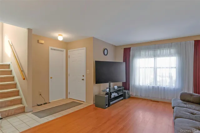 a livingroom with window and a flat screen tv
