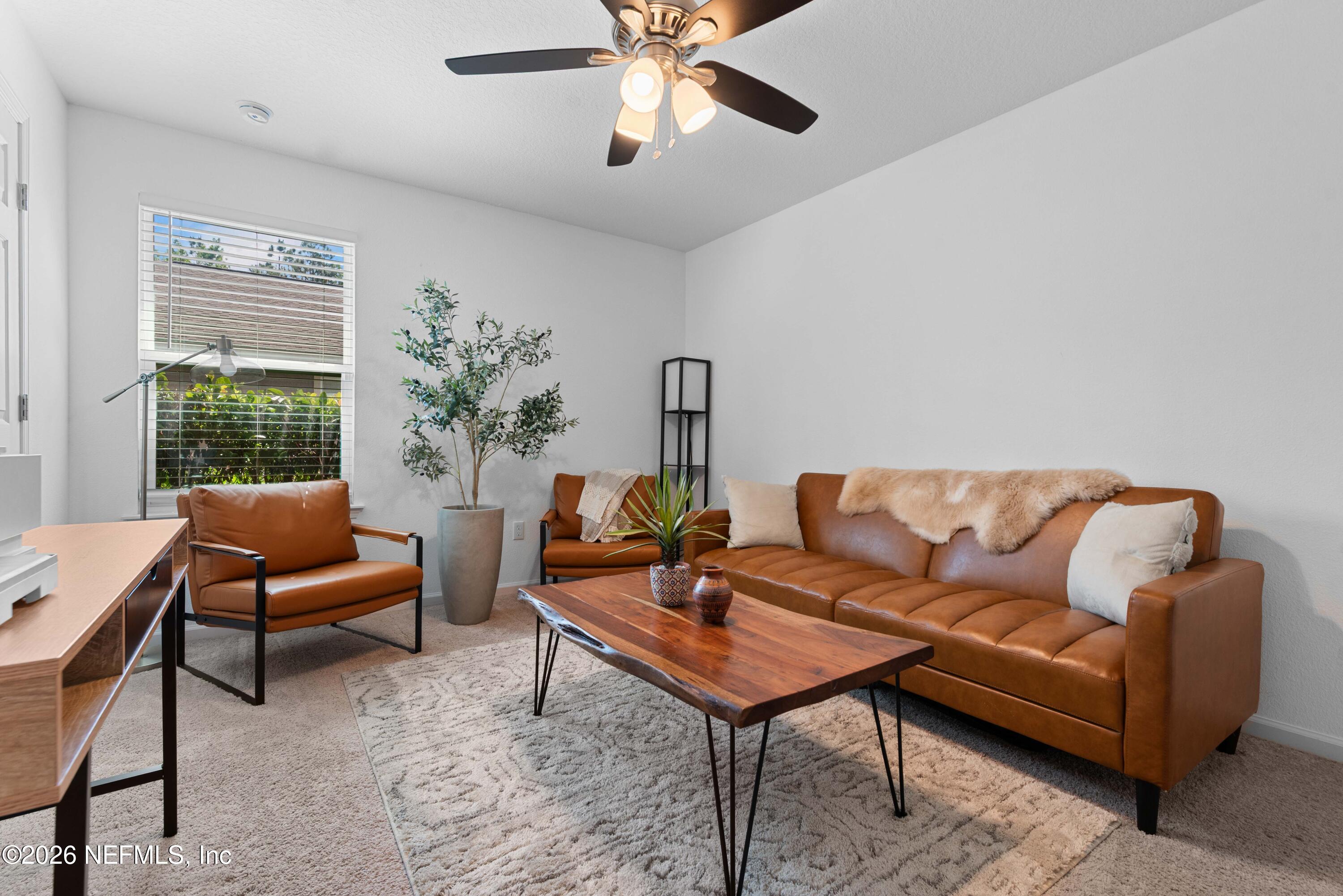 6178 Daylilly Road Macclenny, FL 32063 - Photo 19 of 29 a living room with furniture a rug and a window