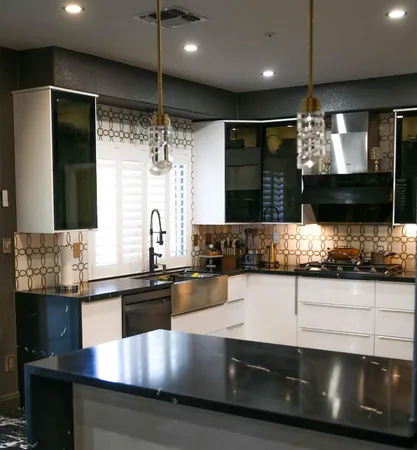 a kitchen with stainless steel appliances kitchen island granite countertop a refrigerator and a sink