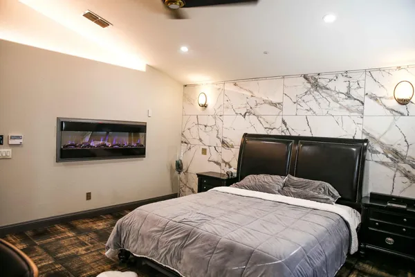 a bedroom with a bed and a painting on the wall