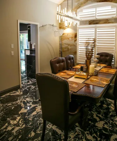 a view of a dining room with furniture and chandelier