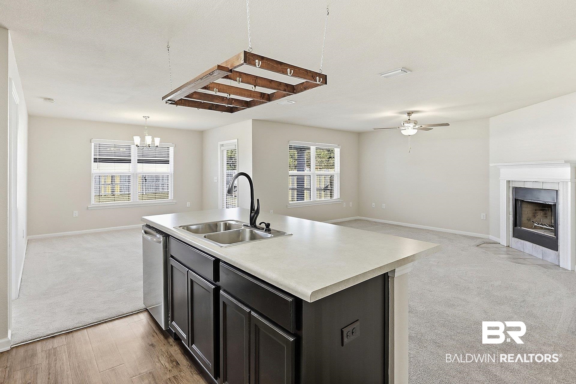983 Summerton Drive Foley, AL 36535 - Photo 25 of 25 Kitchen with open floor plan, light countertops, a kitchen island with sink, a ceiling fan, and a fireplace
