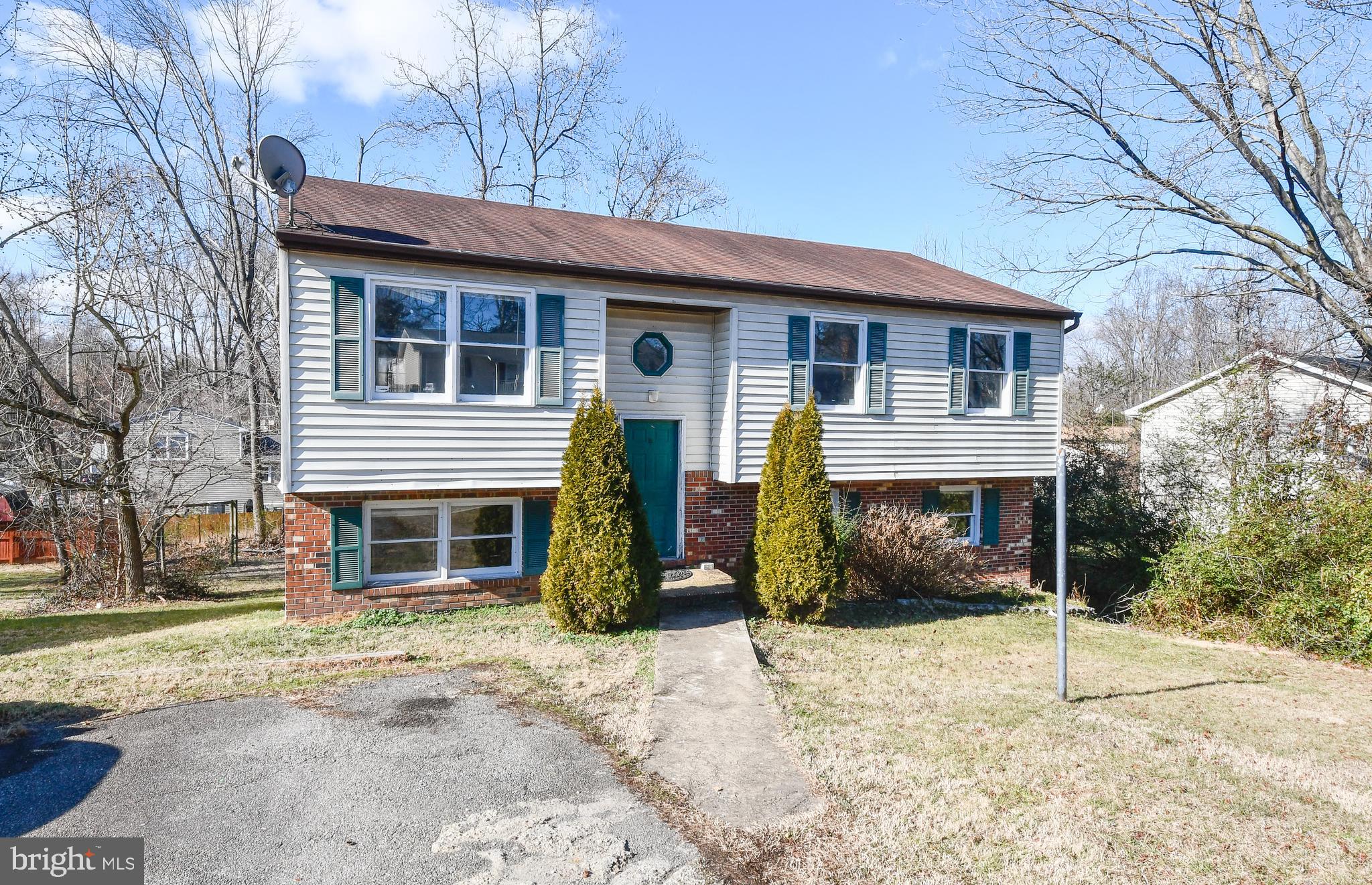 7016 Soulier Lane Fredericksburg, VA 22407 - Photo 1 of 34 a front view of a house with a yard and garage
