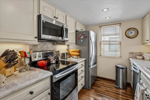 a kitchen with stainless steel appliances granite countertop a stove and a microwave