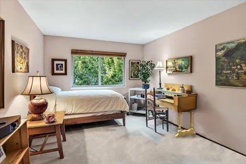 a bed room with a bed and a chair