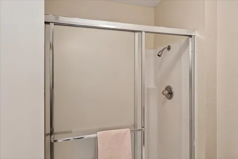 a bathroom with a shower and a sink