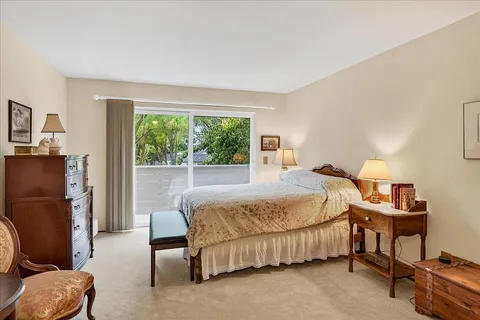 a bedroom with a bed chair and a window