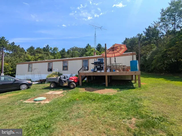 a view of a house with swimming pool and a yard