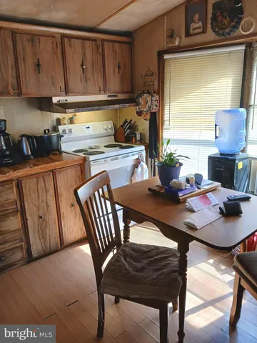 a kitchen with a table chairs and a wooden cabinets