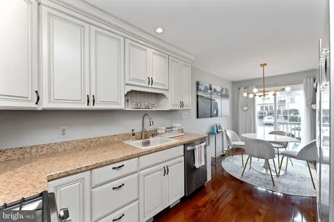 a kitchen with sink cabinets and dining table