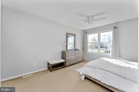 a spacious bedroom with a bed and a couch