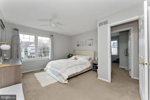 a bedroom with a large bed and a window