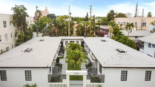 a view of a white building in front of a house