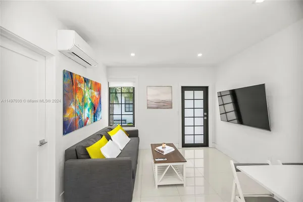 a living room with furniture and a flat screen tv