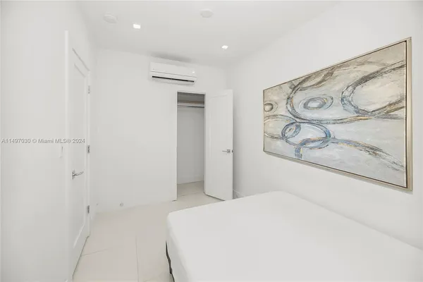 a bedroom with a bed and wall painting