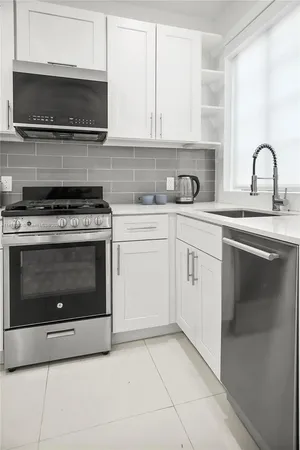 a kitchen with a stove top oven and cabinets