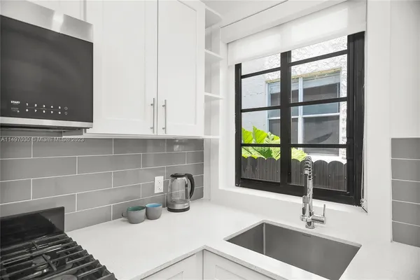 a kitchen with a sink and a window