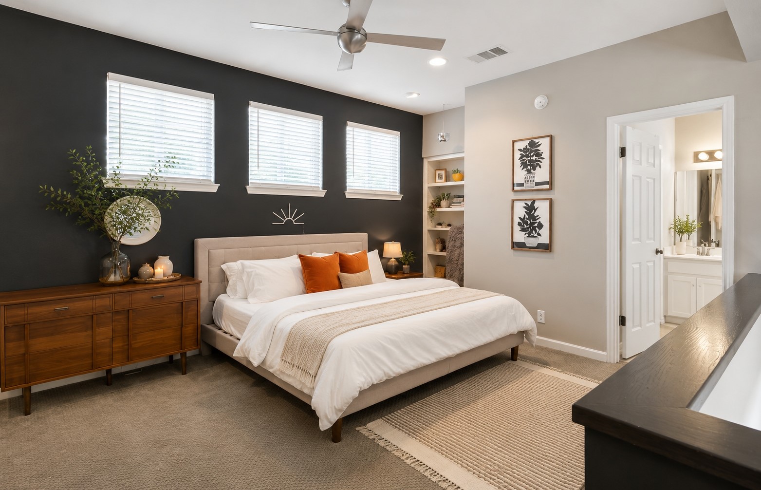 611 East 45th Street, Unit 25 Austin, TX 78751 - Photo 19 of 21 Carpeted bedroom featuring a dark accent wall, three windows with blinds, built-in shelving, and a ceiling fan