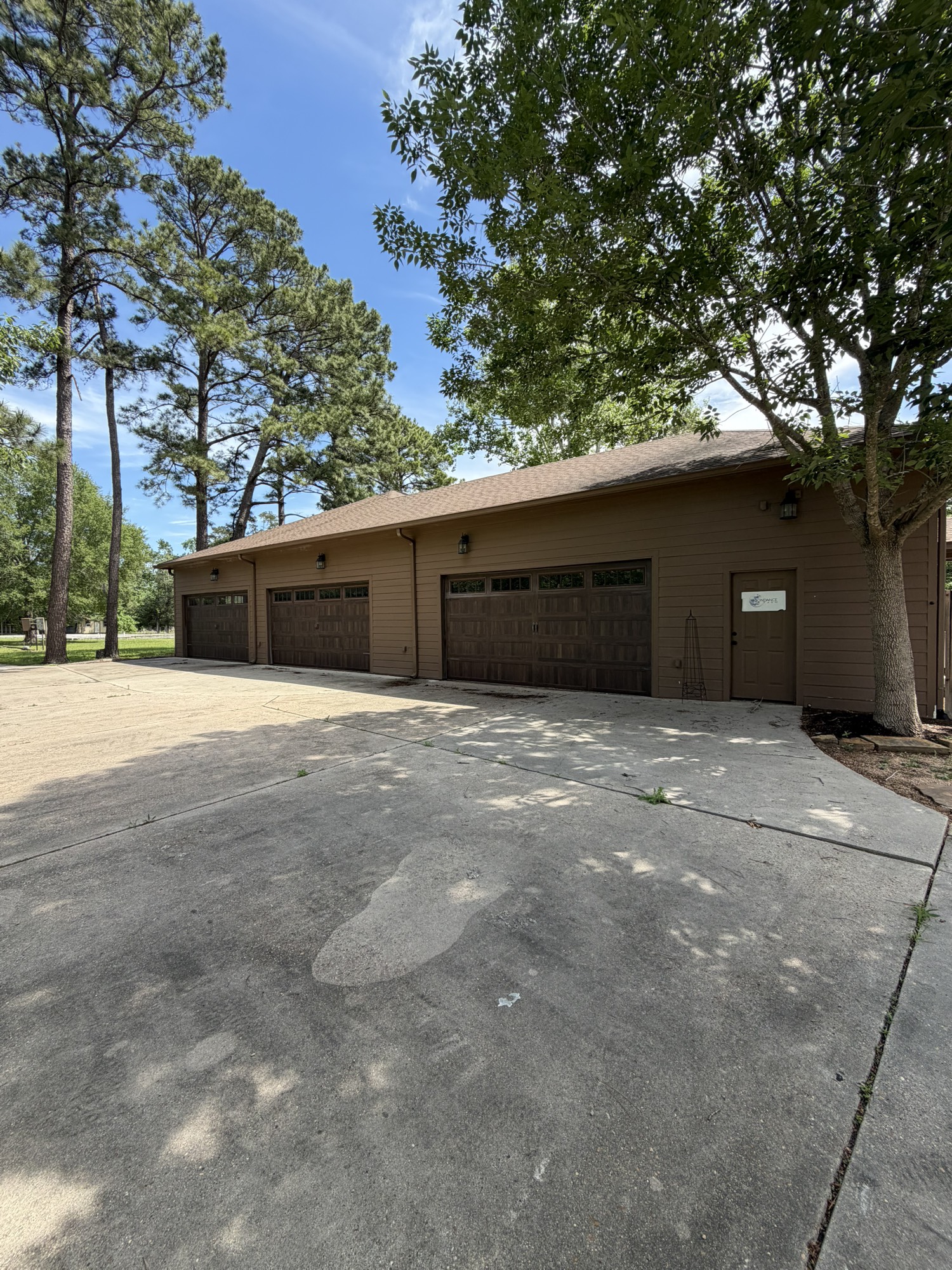 10210 Stidham Road Conroe, TX 77302 - Photo 2 of 39 a front view of a house with a tree