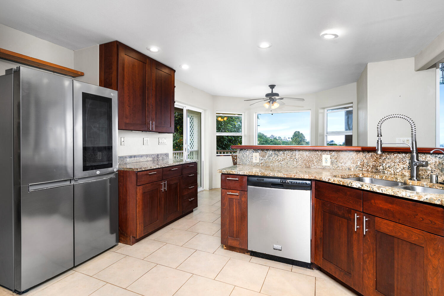 79-1145 Kao Road Holualoa, HI 96725 - Photo 11 of 30 a kitchen with stainless steel appliances granite countertop a refrigerator and a stove top oven