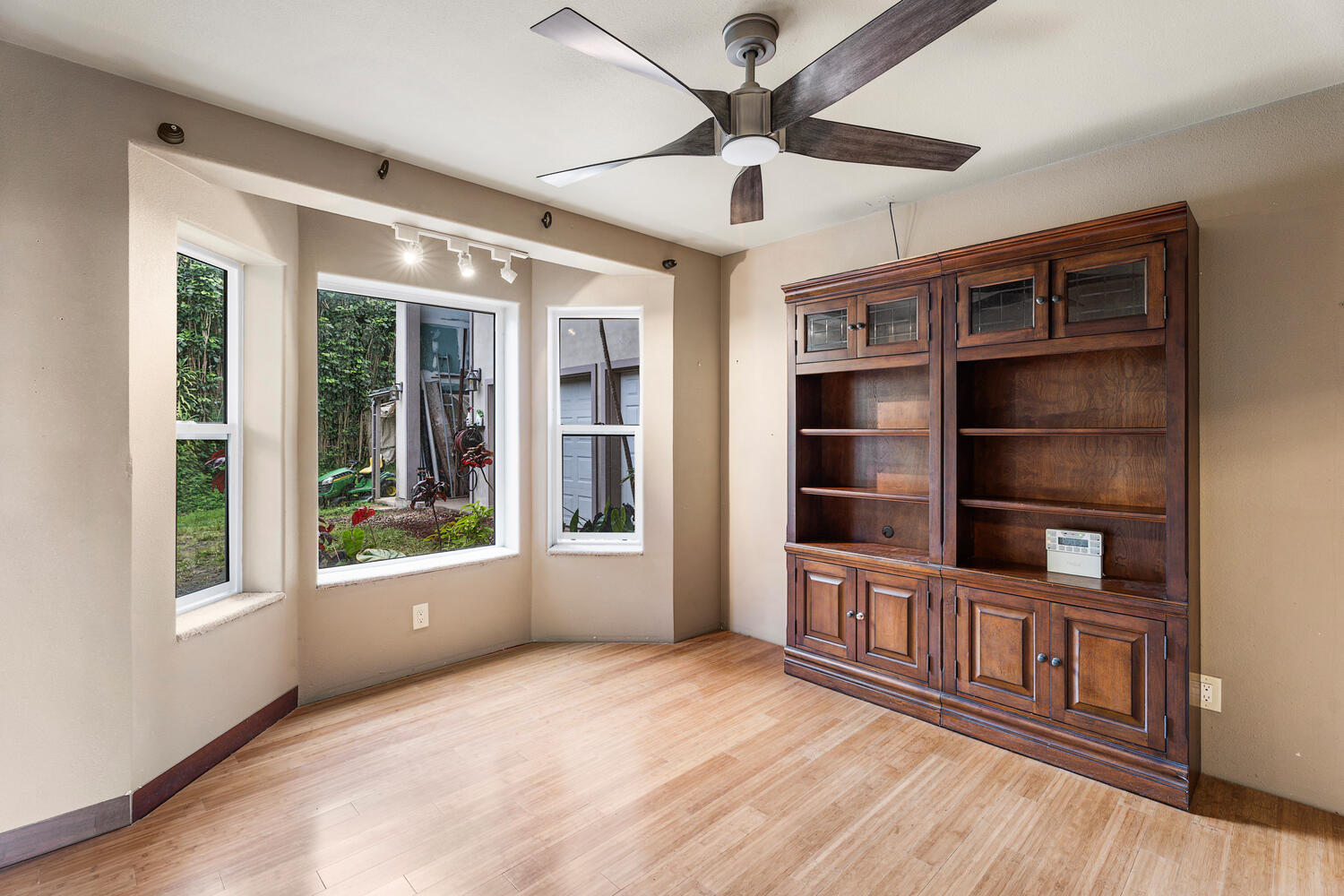 79-1145 Kao Road Holualoa, HI 96725 - Photo 6 of 30 a view of an empty room with a window and wooden floor